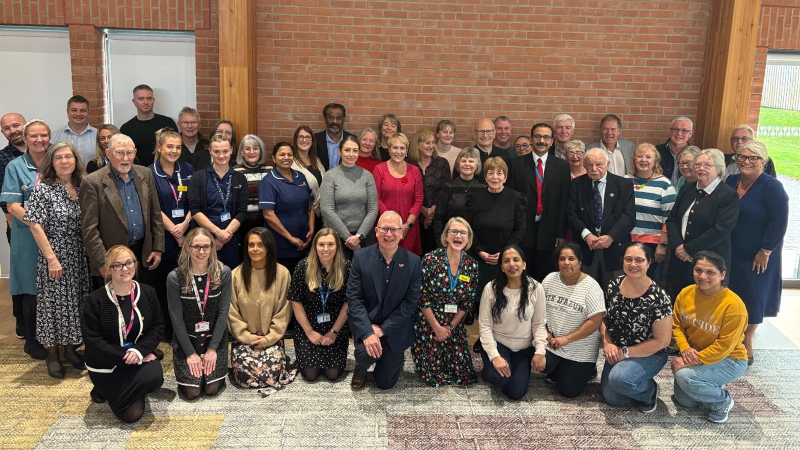 Large group of people smiling to camera