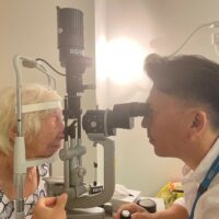 Barbara having eye checked by optician