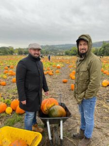 Photo of Joe and Sean in a field of pumpkins