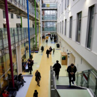 Photo of the entrance hall to Royal Manchester Children's Hospital with people walking