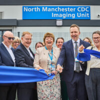 Kathy Cowell and Mark Cubbon cut a ribbon at the new North Manchester CDC Imaging Unit