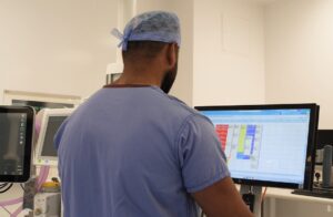 Consultant looking at screen inside new theatre