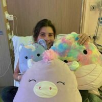 Girl in hospital bed with toys