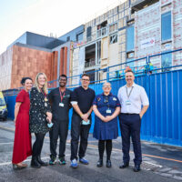 Group of people including Andy Burnham outside the new resus department at MRI