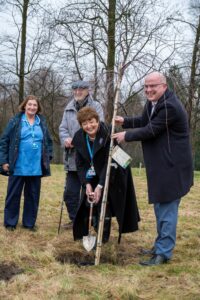 Anne Sullivan, Edmund Hoare, Kathy Cowell and Stephen Dickson (CEO of Trafford Hospital) plant a new tree with the original spade