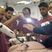 Group of trainees around machine