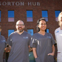 Four staff members stood outside Gorton Hub