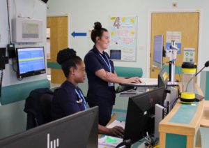 Two staff members working at computers