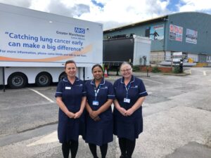 Three staff members stood outside the Lung Cancer Screening mobile clinic.