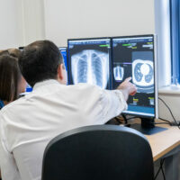 Woman and man looking at an x-ray scan on screen