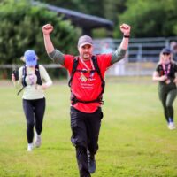 Man running with his arms in the air.