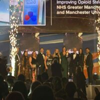 Group winning an award on a stage.