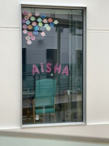 Window with Aisha written across it.
