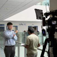 Man talking to interviewer and camera.