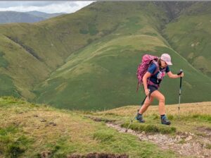 Woman hiking up mountain. 