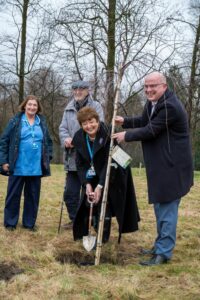 Anne Sullivan, Edmund Hoare, Kathy Cowell and Stephen Dickson (CEO of Trafford Hospital) plant a new tree with the original spade