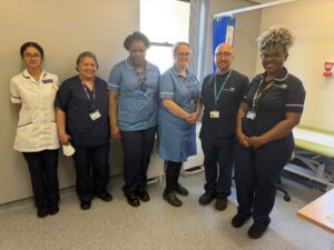 Group of NHS staff stood in ward